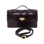 Handbag - cross body - (Tanya) Dark brown crocodile with handle. A front view with lid handle raised and shoulder strap shown not attached.