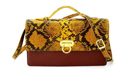 Handbag - cross body - (Tanya) Yellow print leather with handle. The front view with shoulder strap attached.