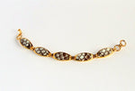 Gold plated bracelet in brown and white sea snake