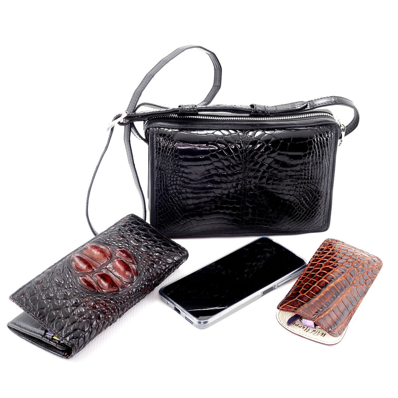 Riley black glaze crocodile elbows showen with the products that can fit into the bag