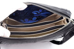 Riley handbag in black glaze crocodile showing the inside pockets and their fabric lining