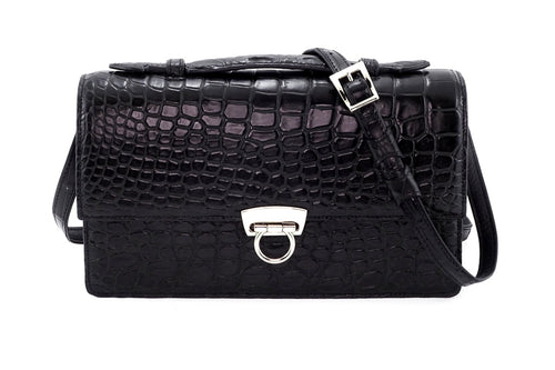 Handbag - cross body - (Tanya)  Black matt crocodile with Handle. Showing the texture of the crocodile. The shoulder strap is attached and the lid handle is sitting flat.