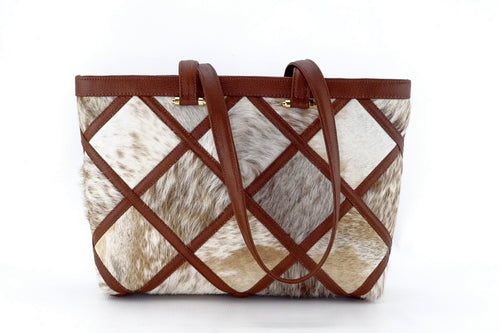 Emily  Tan Hair on hide patchwork leather tote bag outside 