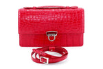 Handbag - cross body - (Tanya)  Red matt crocodile with Handle. The front view with lid handle flat and shoulder strap coiled up in front, removed.