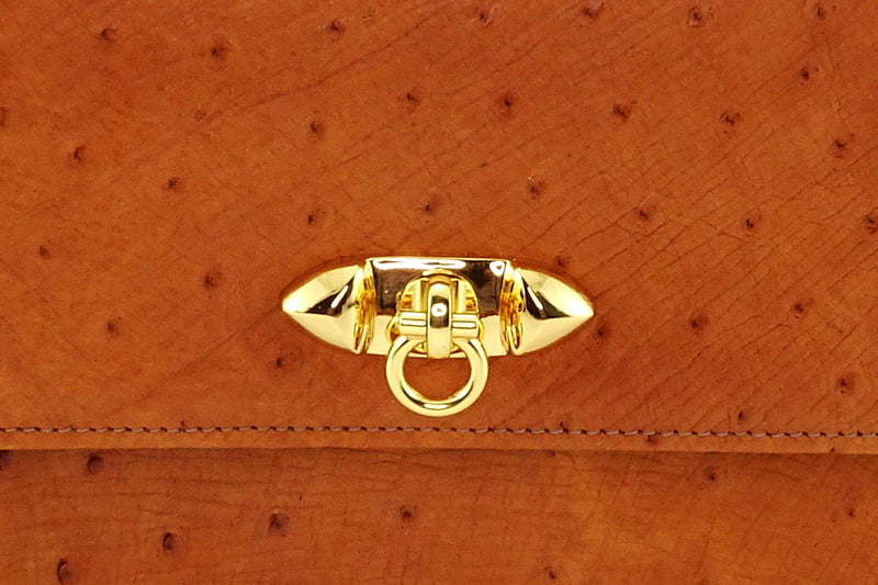 Handbag - cross body - (Tanya) Tan ostrich leather with handle. A close up photo of the details on the gold plated front closure fitting.
