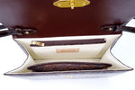 Handbag - cross body - (Tanya) Dark brown crocodile with handle. A view of the inside of the bag showing the leather lining, pocket layout and aboriginal fabric used in the lining.