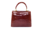 Handbag -traditional - (Beverly) Cognac tan glaze crocodile. This view of the bag is the back showing the slip pocket.