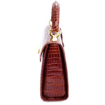 Handbag -traditional - (Beverly) Cognac tan glaze crocodile. The view of the side gusset showing the handle strap attachment.