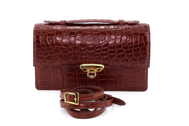 Handbag - cross body - (Tanya) Havana tan matt crocodile with Handle. A front view of lid handle sitting flat and shoulder strap removed and coiled up in front.
