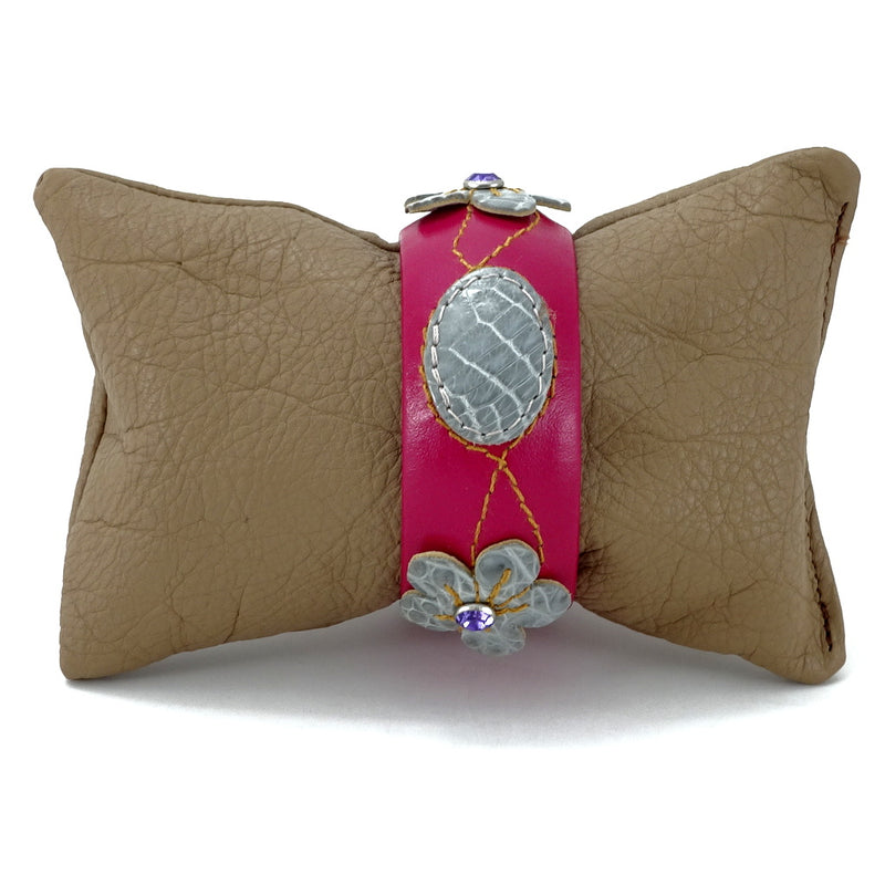 Bangle small (Kim) moulded round decorated leather jewellery - pink & blue crocodile  on hot pink leather shown on display cushion