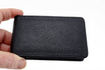 Bill fold wallet outside view black leather held in hand to show size