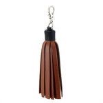 Tassels leather tan with a black cap