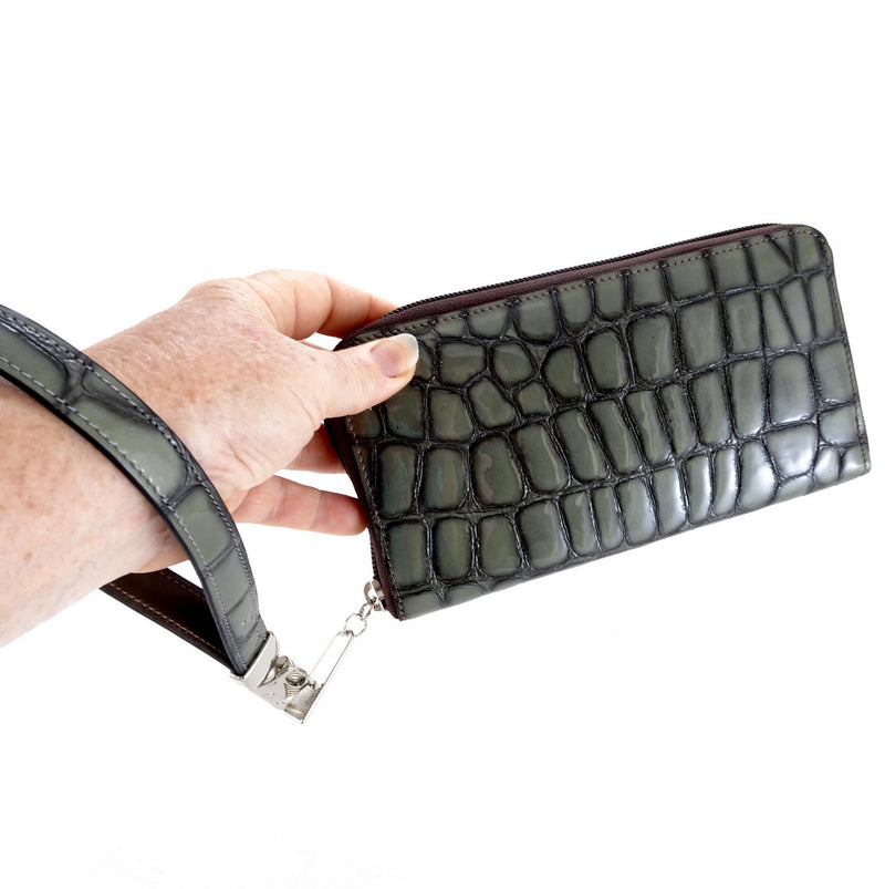 Victoria  Grey foil leather olive internal ladies zip around purse held in hand