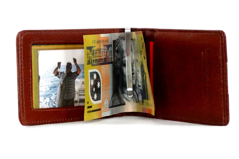 Rusty tan leather bill fold wallet inside view showing all pockets and money clip in use