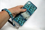 Michaela  Blue & grey snake print leather zip around purse shown on wrist