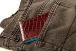 Bill fold burgundy brown wallet sliding into back pocket of jeans size perspective