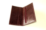 Inside view of suit wallet made in crocodile printed burgundy brown leather cards on left side and zip section right side
