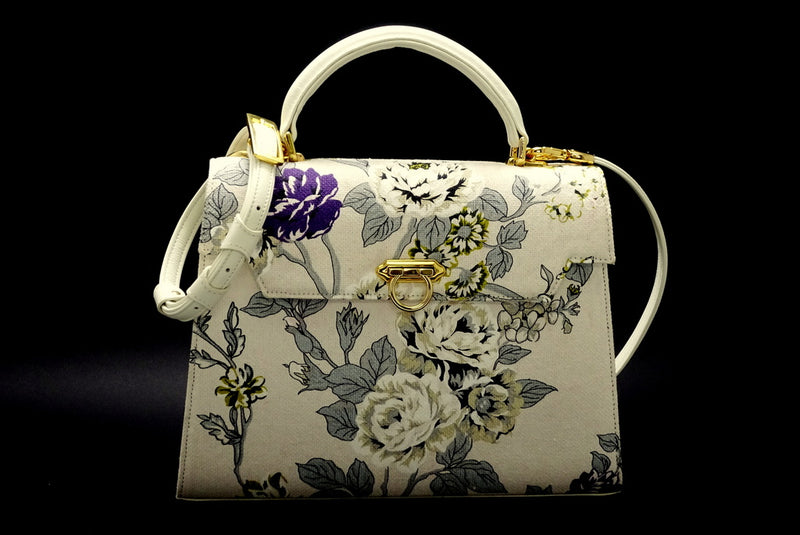 Handbag -traditional - (Joan) Floral canvas & leather - gold fittings showing front view with shoulder strap attached on a black background