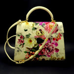 Handbag -traditional - (Joan) - Bright floral canvas & cream leather showing front view with shoulder strap attached on a black background