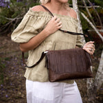 Rosie Chocolate leather small tote bag leather lined fringing showen with model